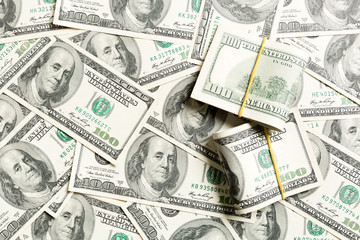Stacks of one hundred dollars banknotes close-up on dollar background business concept top view with copy space
