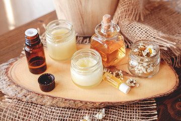 Fototapeta na wymiar Hand cream and lip balm in a glass jar. Natural organic cosmetics with honey, wax and oils.
