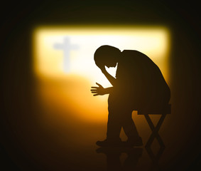 Hope concept: Christian praying for waiting holy spirit over blurred cross of Jesus Christ in dark...