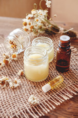Hand cream and lip balm in a glass jar. Natural organic cosmetics with honey, wax and oils.