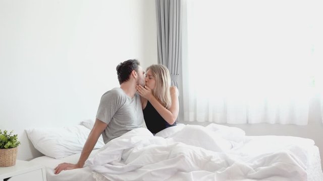 Young couple kissing in the bed .loving couple in bedroom