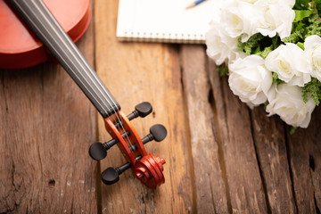 Close-up shot violin orchestra instrumental over wooden background select focus shallow depth of field