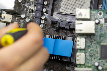Close up. Young Man Repairing Motherboard from PC. Repair Shop. Worker with Tools. Computer...