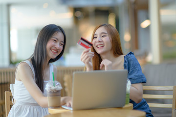 young asian woman buying or shopping online by credit card in hand paying on the website mobile, shopping online anywhere enjoyment