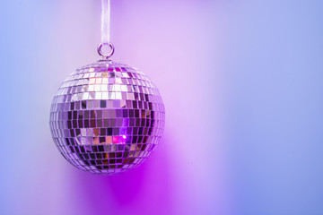 Christmas disco ball on neon pink and blue. Creative Xmas pattern with copy space.