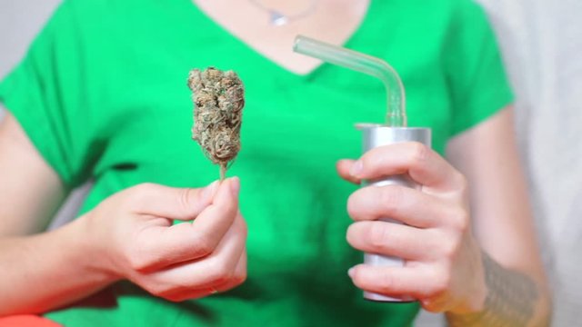 cannabis and vaporizer in patient's hands before smoking medeu marijuana
