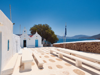 Stone benches beside historic religious building