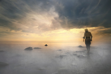 Fototapeta premium traveler sunset, man at sunset travels, extreme vacation, single tourism concept, trekking, landscape with man, beautiful sunset