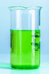 Laboratory flask glassware with reflections on table close up