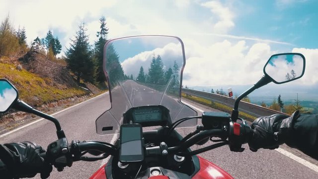 Motorcyclist Rides on a Beautiful Landscape Mountain Road in Slovakia. Serpentine Road