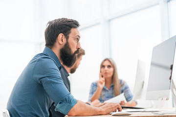 businessman uses a computer to work with documents