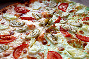 pizza with tomatoes and olives on plate
