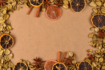 Fototapeta na wymiar Autumn background with golden leaves, dried fruts, cinnamon and anis. Space for text or design.