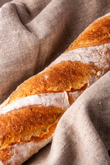 Hot french bagette on roustic wrap in boulangerie. Bred, food, closeup