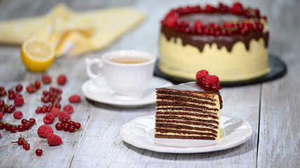 Piece of chocolate Spartak cake on a table. Delicious sweet food on a beautiful plate. Close-up.