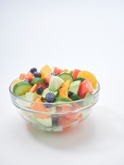 Mixed fruit and vegetable salad in a glass bowl