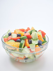 Mixed fruit and vegetable salad in a glass bowl