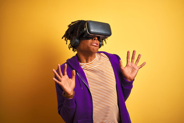 Young african american man playing virtual reality game using goggles