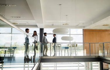 Group of coworkers working together on business project in modern office
