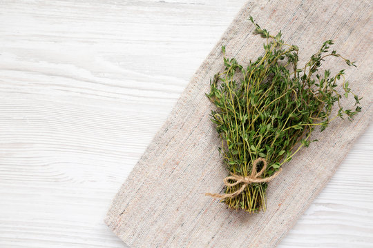Raw organic fresh thyme on cloth. Flat lay, overhead, from above. Copy space.