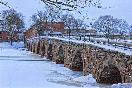Bridge over the river in winter, old stonebridge in Karlstad, Sweden.