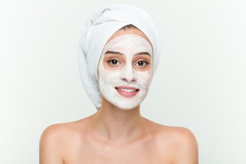 Young caucasian woman enjoying of a facial mask treatment