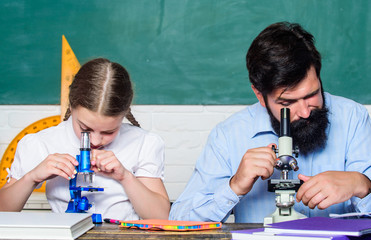 Towards knowledge. father and daughter study in classroom. biology chemistry lesson. bearded man...