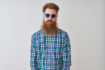 Fototapeta premium Young redhead irish man wearing casual shirt and sunglasses over isolated white background depressed and worry for distress, crying angry and afraid. Sad expression.