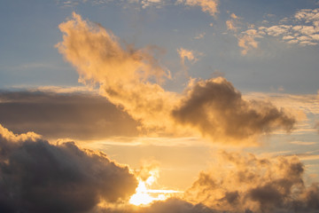 Close up of a drramatic golden blue sunset or sunrise with clouds.