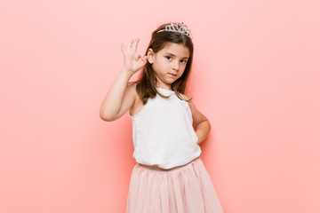 Little girl wearing a princess look cheerful and confident showing ok gesture.