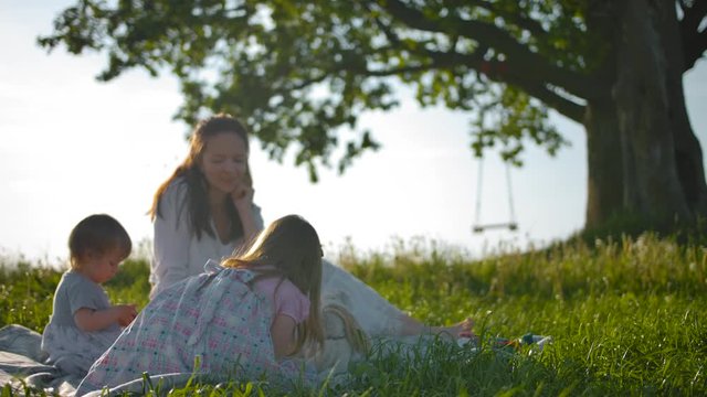 Attractive mummy and her two little babes made a picnic.