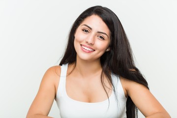 Young hispanic woman against a white background