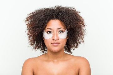 Close up of a young african american woman with an eye skin treatment
