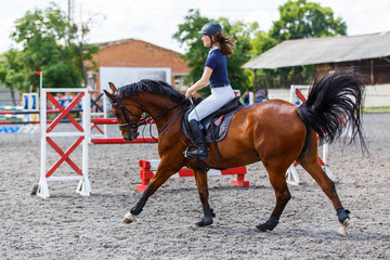 Young female horse rider on equestrian sport event