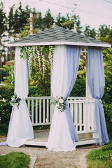 Beautiful white wedding arch made of fabric. decor