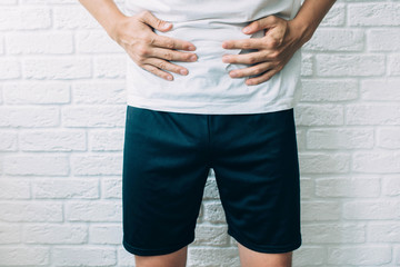 cropped male body suffering stomach ache. diarrhea, cramping and abdominal pain