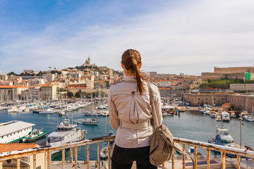 Tourist woman in French historical city Marseille and Mediterranean sea coast. Marseille is the...