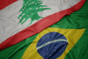 waving colorful flag of brazil and national flag of lebanon.