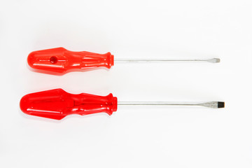 two old rusty metal screwdrivers with red a handles