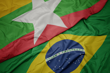 waving colorful flag of brazil and national flag of myanmar.