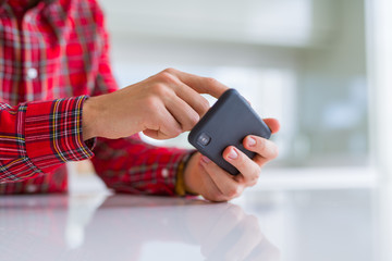 Close up of man hands using smartphone and smiling