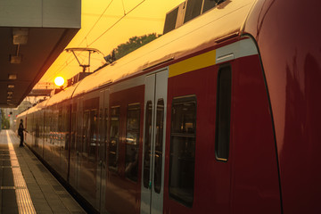 Train at sunrise in the railway station. German passengers train