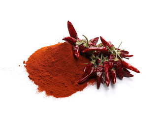 Dry red, spicy peppers with powder pile isolated on white background