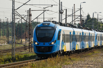 Obraz premium ELECTRIC MULTIPLE UNIT - Modern passenger train on the railway route