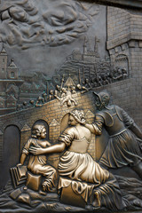 Legends of old Prague: a place of making wishes - a bronze ancient bas-relief on Charles Bridge below the statue of Jan Nepomuk