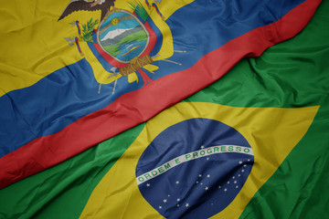 waving colorful flag of brazil and national flag of ecuador.