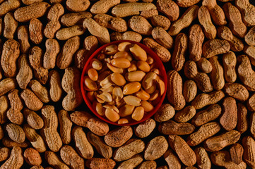 Peanut in a shell texture, background of peanuts with a plastic plate