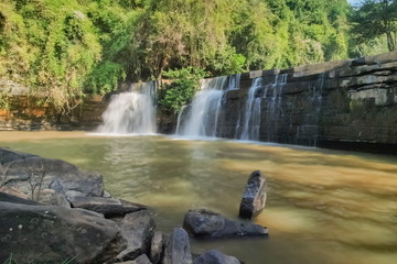 view of waterfall flowing around with arch rocks and green forest background, Sridit Waterfall, Khao Kho, Phetchabun, thailand.