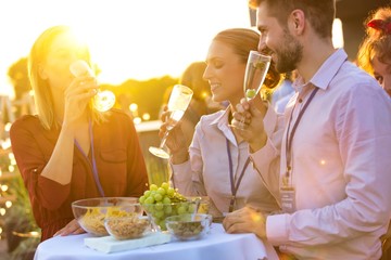 Young business colleagues talking during rooftop party