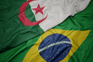 waving colorful flag of brazil and national flag of algeria.